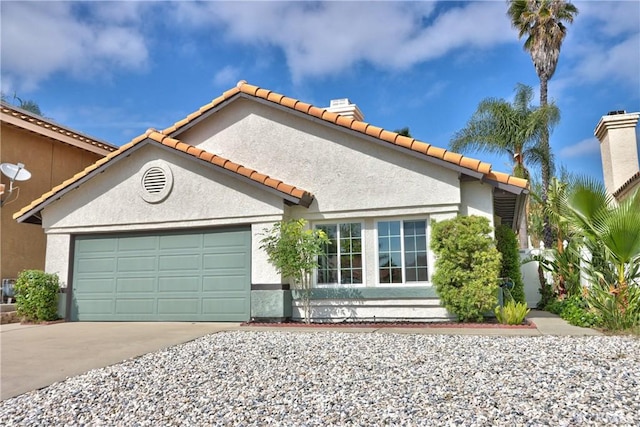 mediterranean / spanish-style home with stucco siding, an attached garage, a tile roof, and driveway