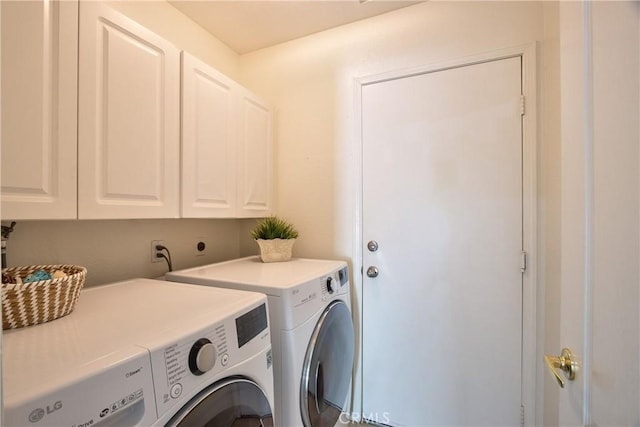 laundry room with cabinet space and separate washer and dryer