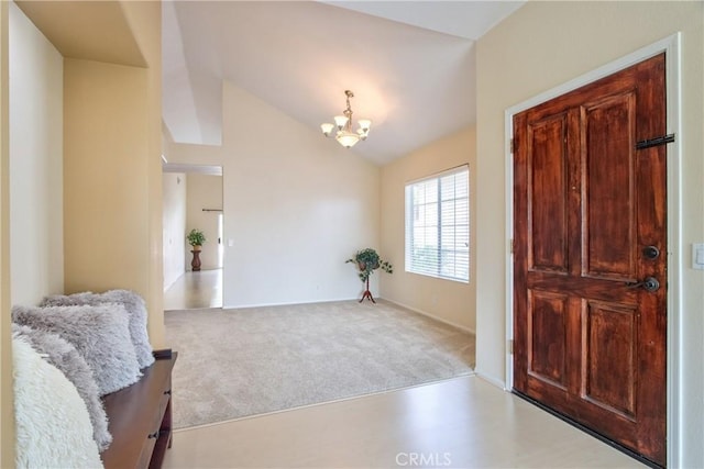 entryway featuring an inviting chandelier, lofted ceiling, and carpet