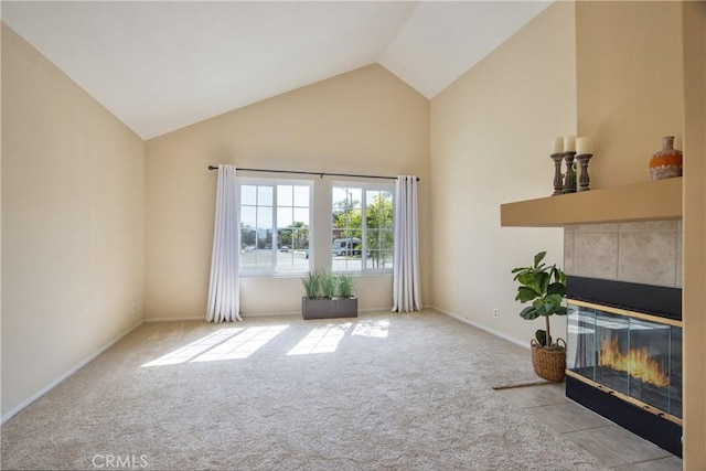 living room with high vaulted ceiling, baseboards, carpet flooring, and a tile fireplace
