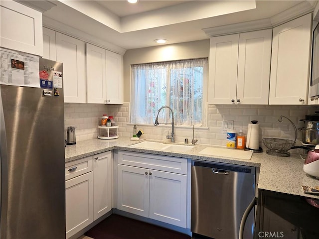 kitchen featuring a sink, white cabinets, stainless steel appliances, backsplash, and recessed lighting
