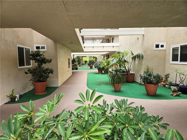 view of yard featuring a balcony and a patio