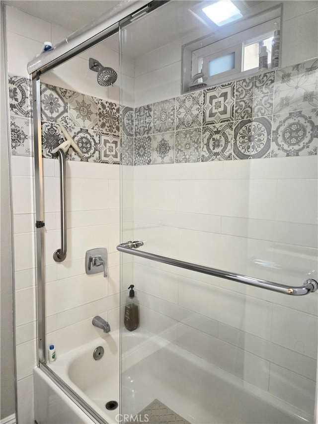 bathroom with shower / bath combination with glass door
