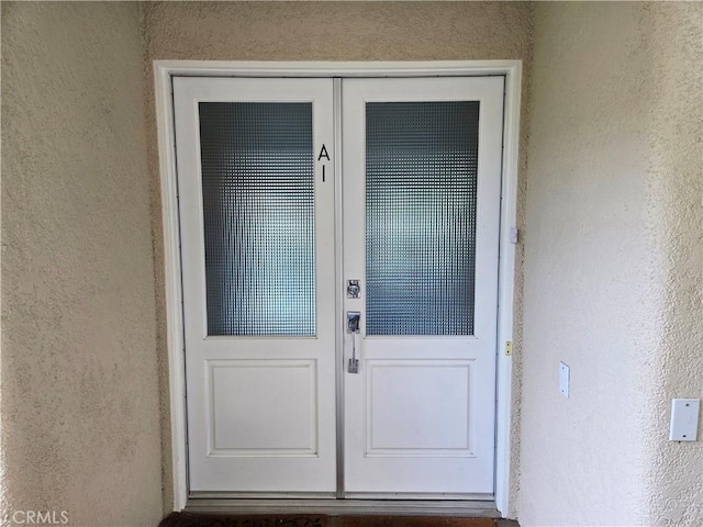 property entrance with stucco siding