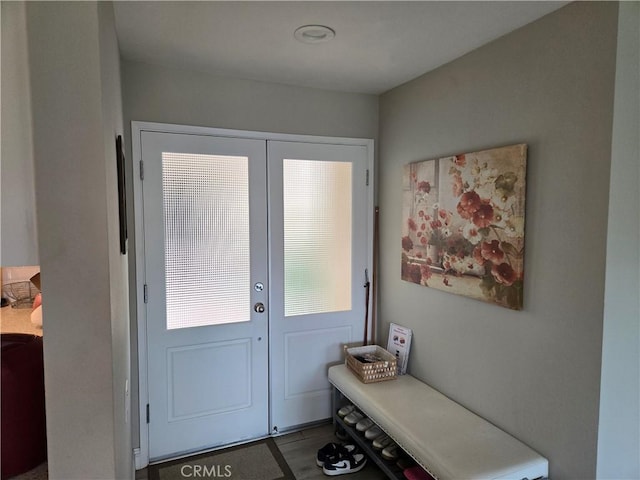 entryway with tile patterned floors and french doors