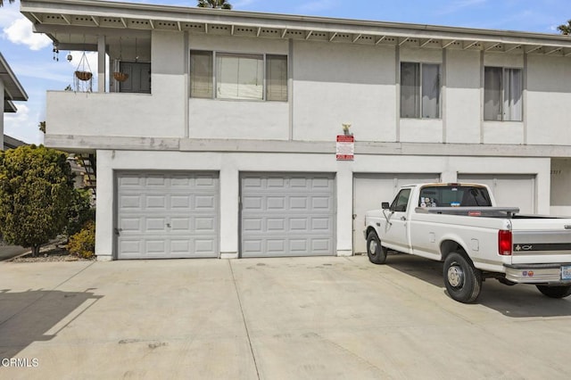 2515 Harbor Blvd Unit 1, Ventura, CA 93001 - townhome / multi-family property featuring an attached garage, concrete driveway, and stucco siding