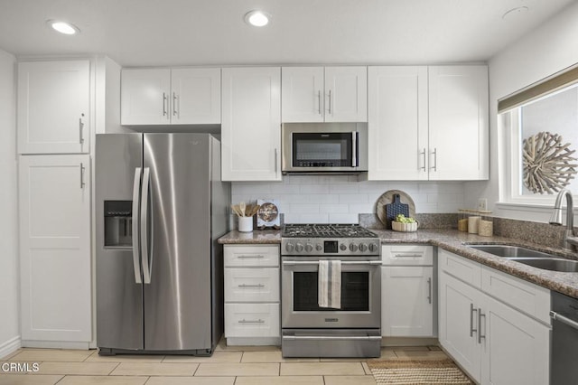 2515 Harbor Blvd Unit 1, Ventura, CA 93001 - kitchen featuring appliances with stainless steel finishes, a sink, white cabinetry, stone counters, and recessed lighting