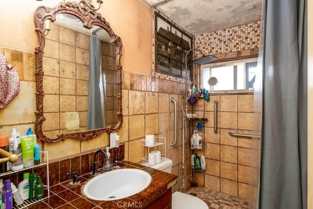 full bath featuring a shower stall, tile walls, toilet, and vanity