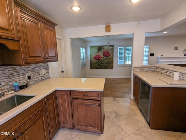636 N C St, Oxnard, CA 93030 - kitchen featuring a peninsula, tasteful backsplash, wine cooler, and light countertops