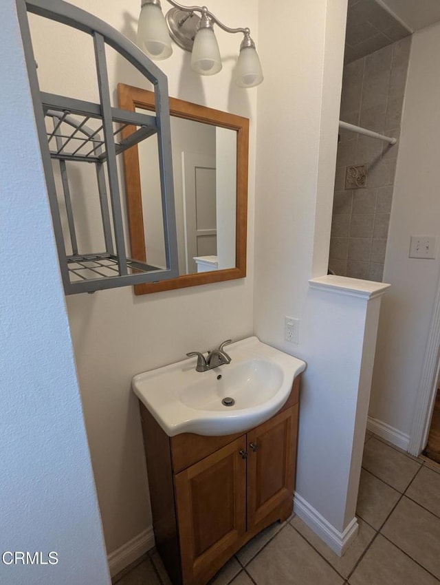 636 N C St, Oxnard, CA 93030 - bathroom featuring a tile shower, vanity, baseboards, and tile patterned floors