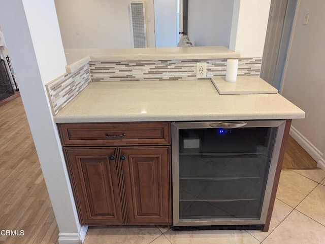 636 N C St, Oxnard, CA 93030 - details featuring tasteful backsplash, wood finished floors, a heating unit, beverage cooler, and baseboards