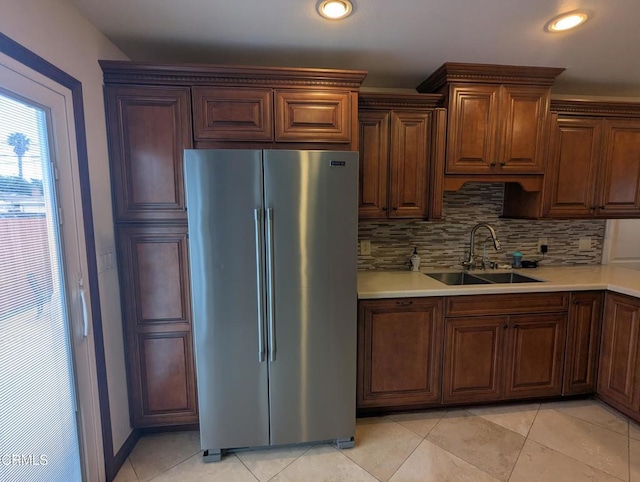636 N C St, Oxnard, CA 93030 - kitchen featuring a sink, light tile patterned flooring, high end fridge, backsplash, and light countertops