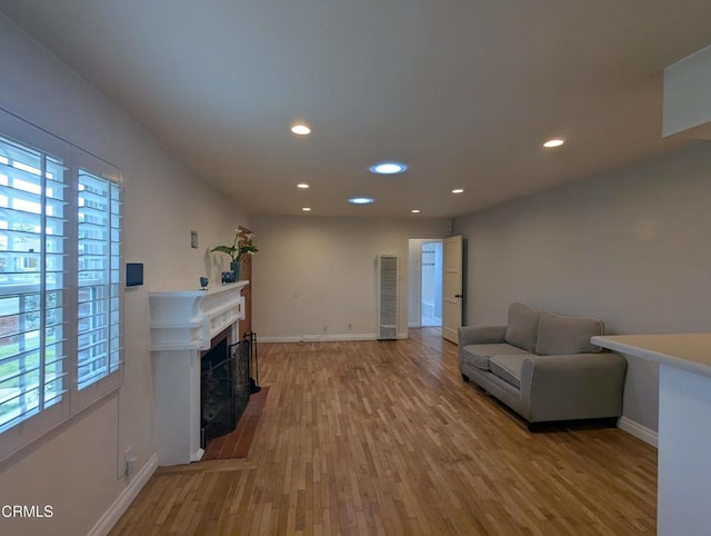 636 N C St, Oxnard, CA 93030 - living area featuring light wood-type flooring, baseboards, a fireplace with flush hearth, and recessed lighting