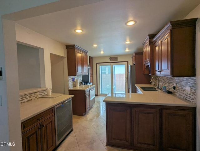 636 N C St, Oxnard, CA 93030 - kitchen with a sink, tasteful backsplash, freestanding refrigerator, wine cooler, and light countertops