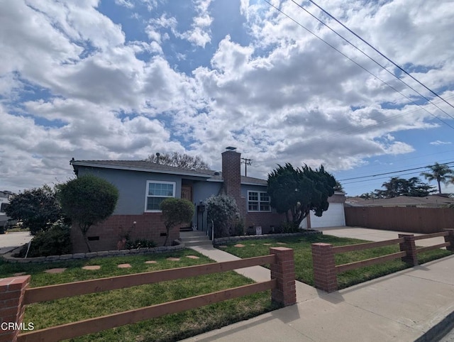 636 N C St, Oxnard, CA 93030 - ranch-style house with brick siding, driveway, a front yard, fence private yard, and a chimney