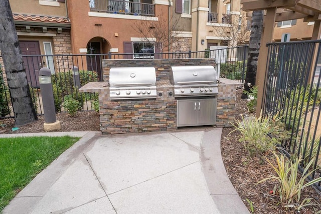 view of patio / terrace with a grill, area for grilling, and fence