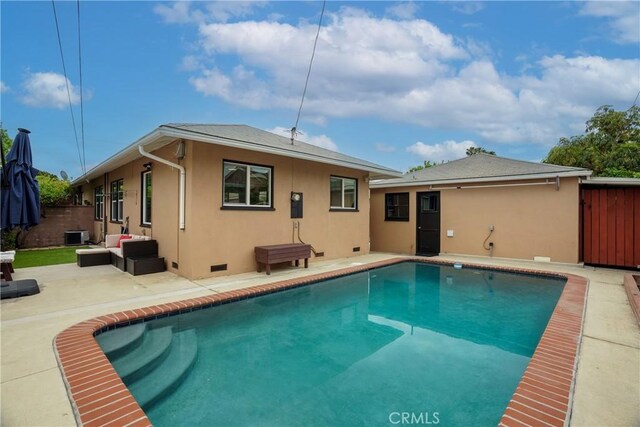 rear view of house featuring a fenced in pool, fence, stucco siding, a patio, and an outdoor living space