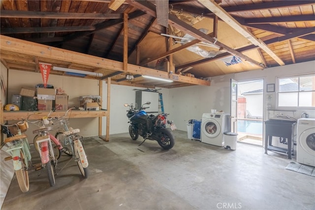 garage with washer / dryer, wood ceiling, and a sink