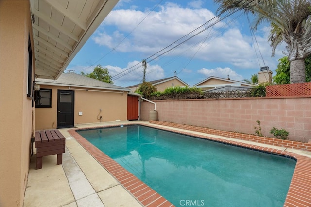 view of swimming pool featuring a fenced in pool and fence
