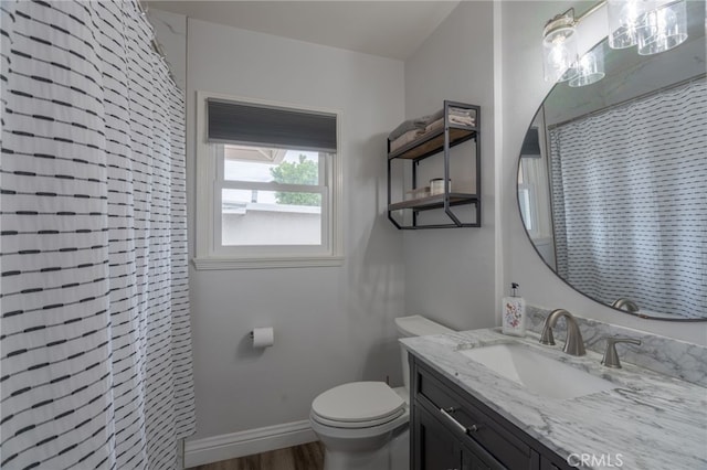 full bath featuring toilet, vanity, wood finished floors, and curtained shower