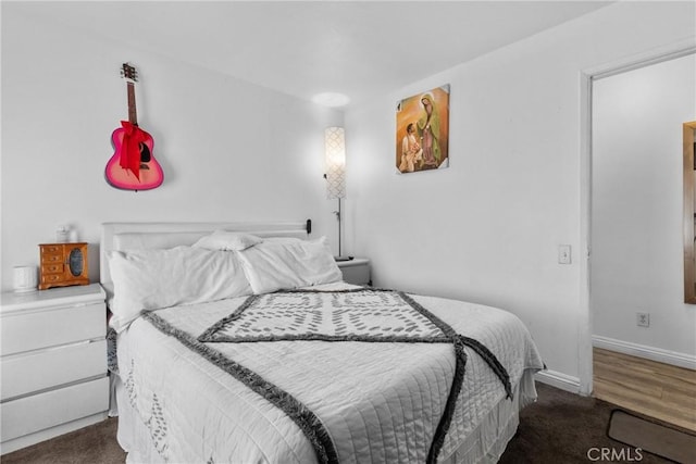 carpeted bedroom with baseboards