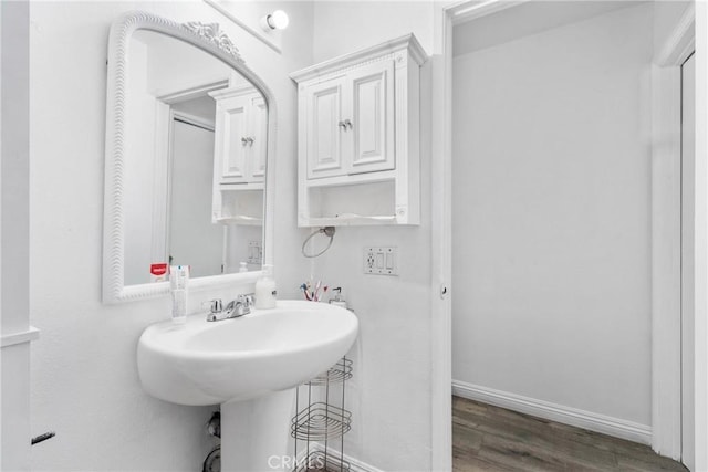 bathroom featuring baseboards and wood finished floors