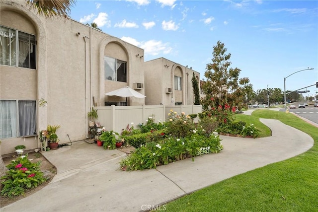 surrounding community with fence and a yard