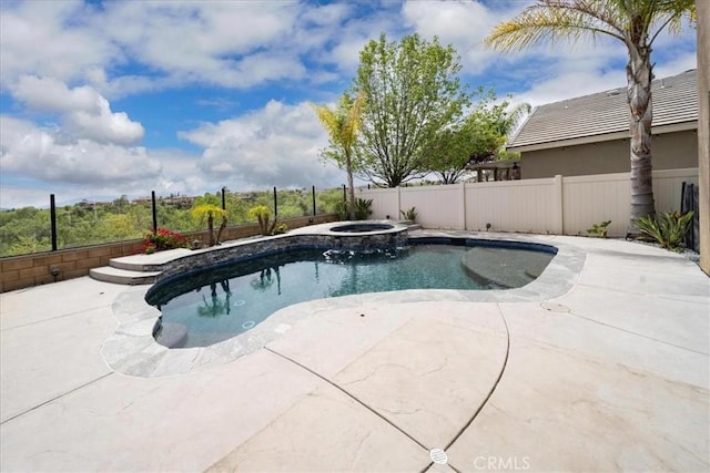 view of swimming pool with a patio area, a pool with connected hot tub, and a fenced backyard