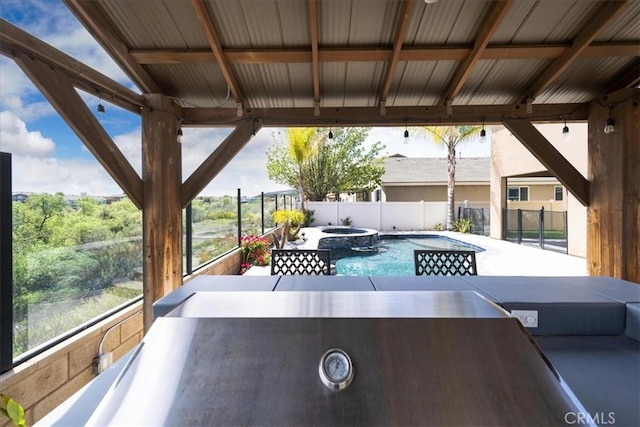 view of patio with a pool with connected hot tub and a fenced backyard