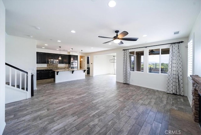 unfurnished living room with recessed lighting, visible vents, wood finished floors, and ceiling fan