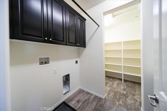 laundry room with hookup for an electric dryer, baseboards, washer hookup, cabinet space, and wood finished floors