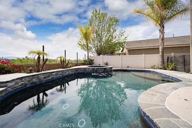 view of swimming pool featuring a fenced backyard and a pool with connected hot tub