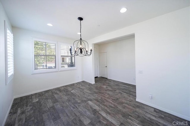 unfurnished dining area with baseboards, recessed lighting, a chandelier, and dark wood finished floors