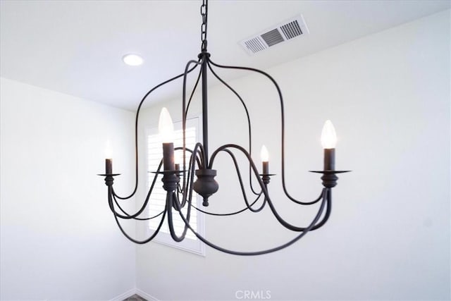 interior details with visible vents and a notable chandelier