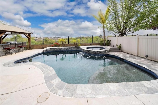 view of swimming pool with a patio, a gazebo, a fenced backyard, and a pool with connected hot tub