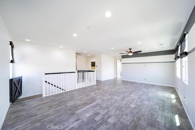 unfurnished room featuring wood finished floors, ceiling fan, baseboards, and recessed lighting