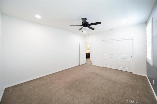 unfurnished bedroom featuring recessed lighting, a closet, baseboards, and carpet floors