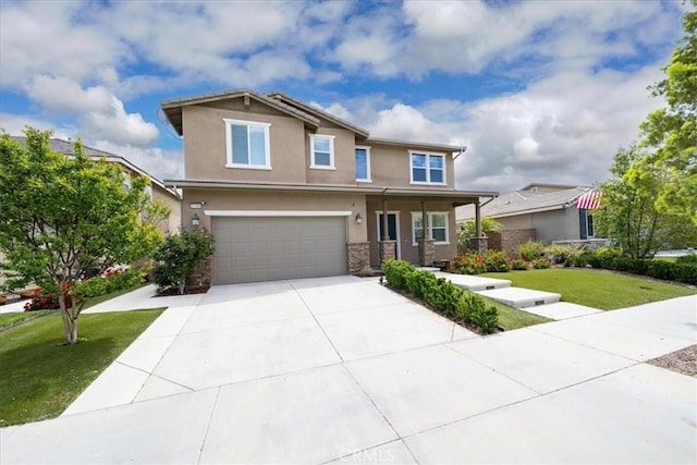 craftsman house with concrete driveway, stucco siding, stone siding, an attached garage, and a front lawn