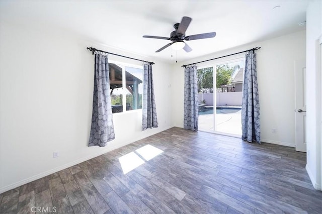 unfurnished room featuring baseboards, a ceiling fan, and wood finished floors