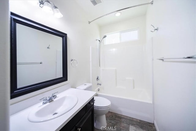 bathroom with vanity, bathtub / shower combination, and toilet
