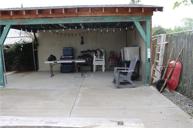 216 Barros St, Patterson, CA 95363 - view of patio featuring a garage and fence