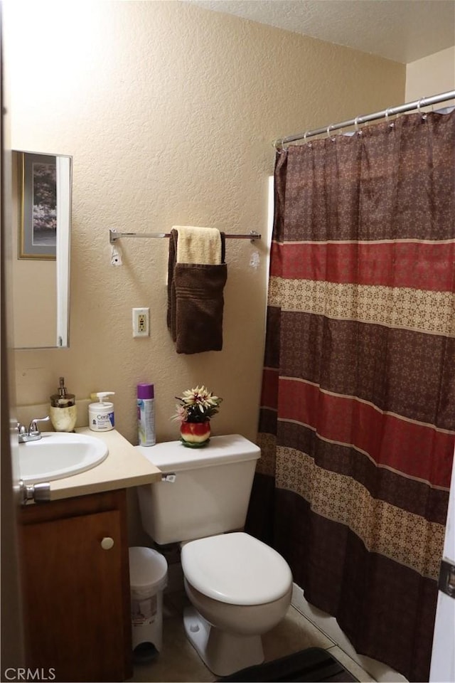 216 Barros St, Patterson, CA 95363 - full bathroom featuring toilet, a textured wall, vanity, and a shower with curtain