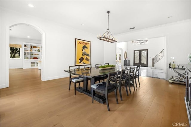 5366 Collingwood Cir, Calabasas, CA 91302 - dining room with arched walkways, wood finished floors, crown molding, stairs, and recessed lighting
