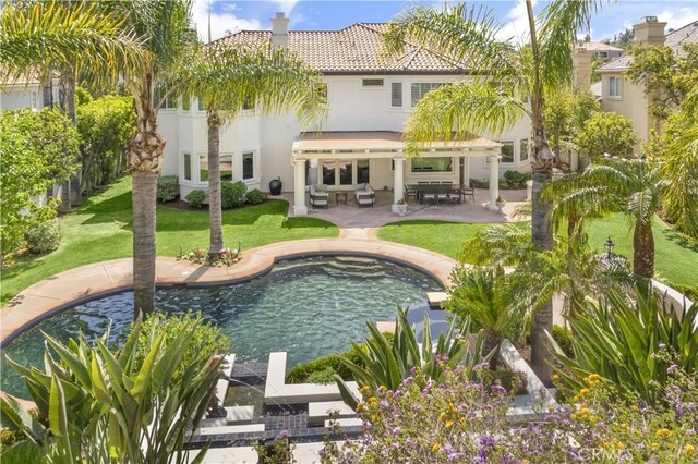 5366 Collingwood Cir, Calabasas, CA 91302 - rear view of house with a tile roof, a patio area, stucco siding, and a lawn