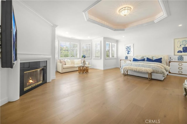 5366 Collingwood Cir, Calabasas, CA 91302 - bedroom with wood finished floors, a glass covered fireplace, baseboards, a tray ceiling, and ornamental molding