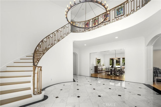 5366 Collingwood Cir, Calabasas, CA 91302 - tiled foyer entrance with arched walkways, a high ceiling, stairway, recessed lighting, and baseboards