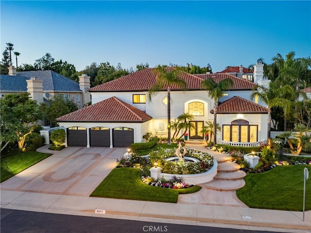 5366 Collingwood Cir, Calabasas, CA 91302 - mediterranean / spanish home featuring french doors, a tile roof, a garage, concrete driveway, and stucco siding