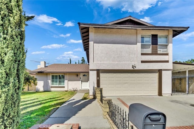 view of front of home with fence, a front lawn, concrete driveway, stucco siding, and a garage