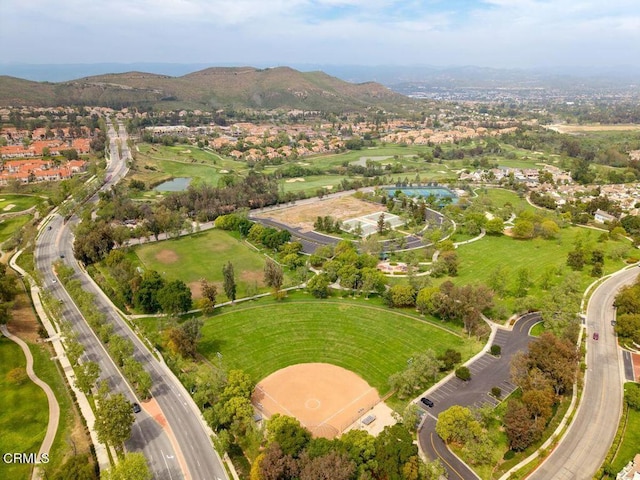 drone / aerial view featuring a water and mountain view and a residential view
