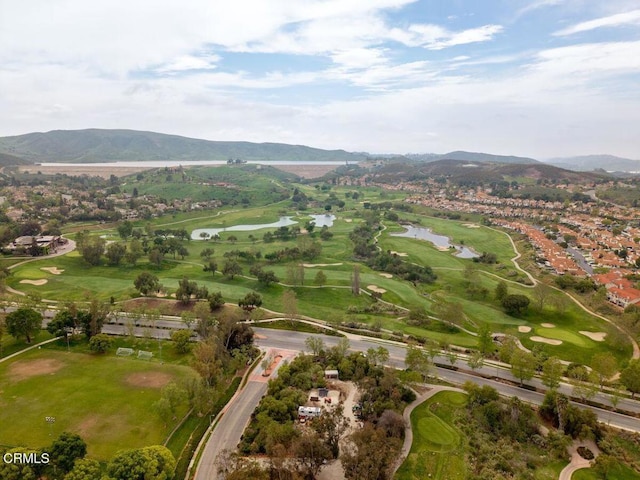 birds eye view of property with a water and mountain view, golf course view, and a residential view